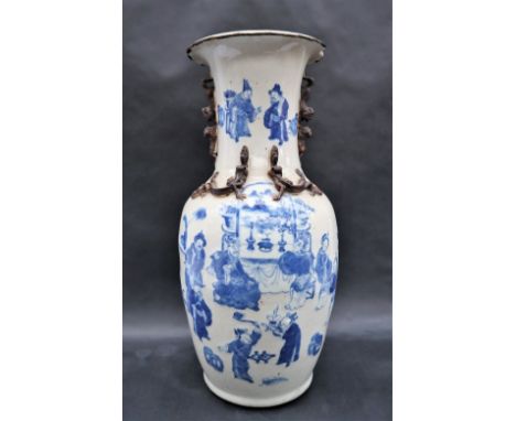 A Chinese blue and white baluster vase decorated with applied dragons, the body with underglazed blue figures in an interior,