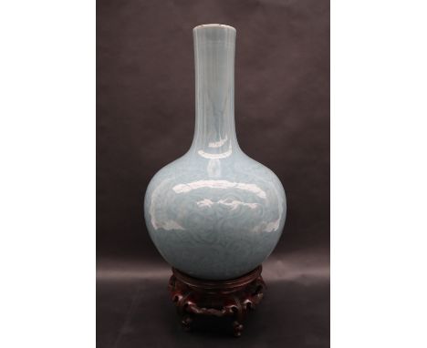 A 19th century Chinese blue Celadon bottle vase, decorated with scrolling leaves, seal mark to the base, 34.5cm high on a car