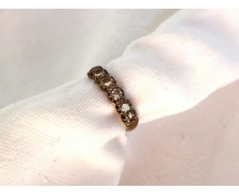 A diamond half eternity ring set with eight round brilliant cut diamonds to a white metal setting and shank, approximately 3 