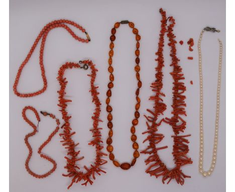 A graduated pearl necklace with a silver and marcasite clasp together with an amber bead necklace and parts of coral necklace