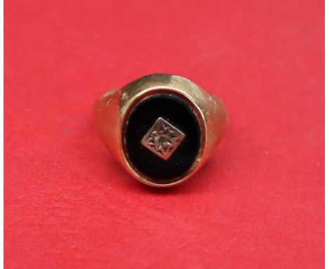 A 9ct gold signet ring set with an onyx panel, size K 1/2 approximately 5.5 grams