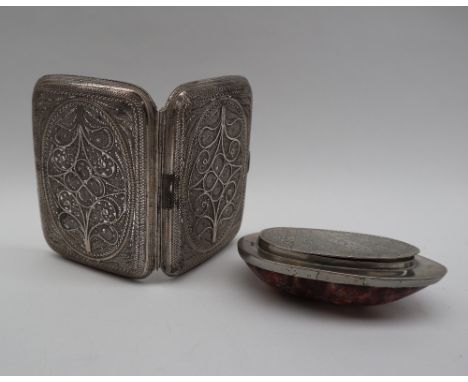 A white metal wirework cigarette case decorated with scrolls and stylised flowers, 9cm x 7cm, approximately 87 grams together