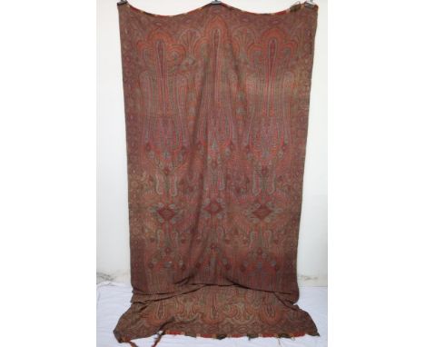 A Victorian paisley Shawl with a note stating "This shawl was a present to my grandmother from her uncle who bought it at the