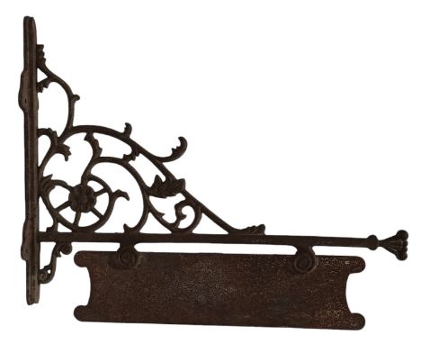 An early 20th-century cast iron wall mounted hanging shop sign. The sign mounted upon a scrolled cast iron wall bracket.Measu
