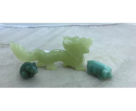 A nephrite jade polar bear, bowenite pig and onyx dragon