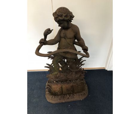 A cast iron stick stand in the form of a boy grasping a snake