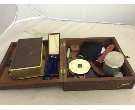 A box of odds to inc a vintage church service book with clasp, sovereign scales, badges, pietra dura pin, pocket watch, fruit