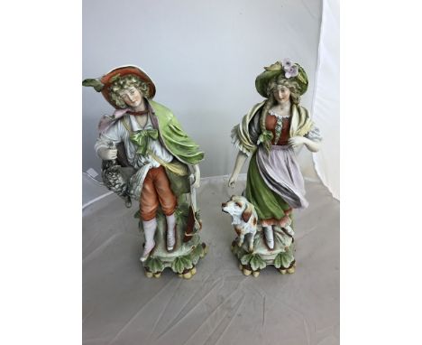 A large pair of German ceramic figurines: man with gun and woman and dog