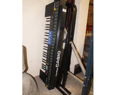 A CASIO KEYBOARD PLUS A STAND