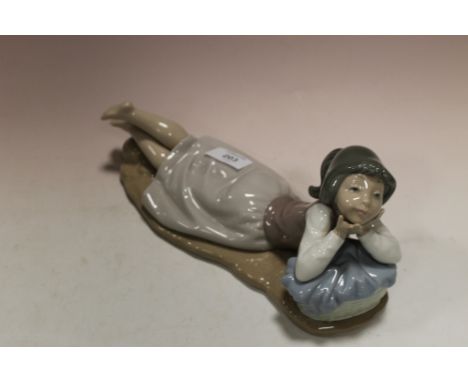 A LARGE NAO FIGURINE OF A GIRL LYING DOWN