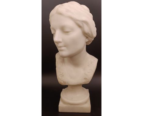 Attributed to Honora M Rigby, a carved marble bust portrait of a young lady, on a socle base, 48 cm high, with a period monoc