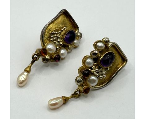 A pair of yellow and white metal cabochon cut gem set abstract earrings