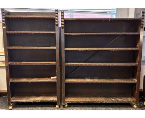 Two dark wood open Book cases with leather and nail head trim, raised on roller feet.[174cm x 91.5cm x 28cm] [171cm x 137cm x