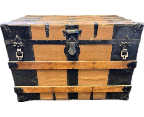An antique wood and metal bound travel trunk, with initials M.C.H [57x81x49] 