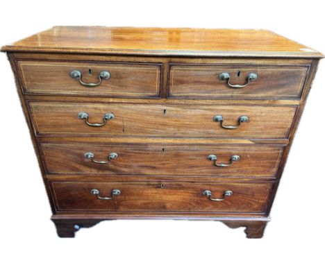 Georgian chest of drawers, the shaped surface above two short drawers and three graduating long drawers, raised on carved bra