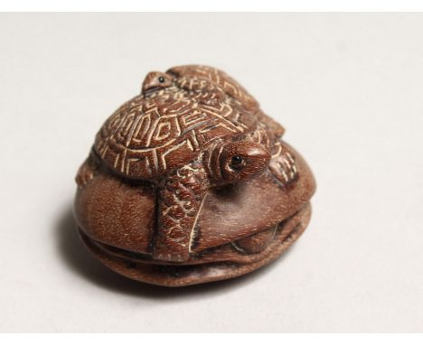 A JAPANESE CARVED WOOD TURTLE GROUP NETSUKE