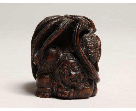 A JAPANESE CARVED WOOD DRAGON NETSUKE