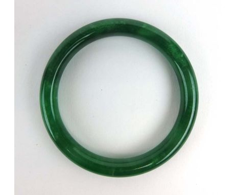 A dark green jade bangle, internal d. 6.4 cm