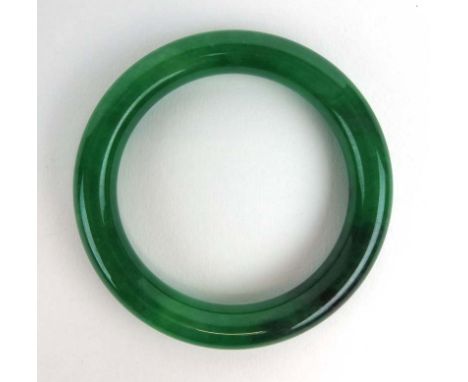 A dark green jade bangle, internal d. 5.8 cm