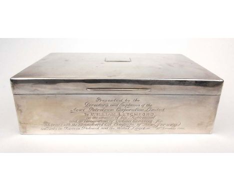 A large silver presentation cigarette box having engine turned decoration to top. Hallmarked for London, 1935. Approx weight 