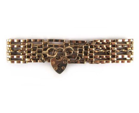 A 9ct gold five bar gate link bracelet with padlock claps and safety chain. Approx weight 20.6g