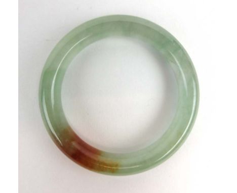 A green jade bangle, internal d. 5.9 cm