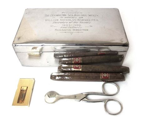 An Edwardian silver presentation cigar box complete with cigars, gold plated cigar cutter and scissors. Hallmarked for London