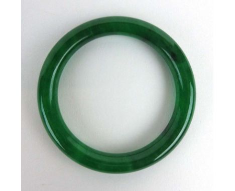 A green jade bangle, internal d. 5.8 cm