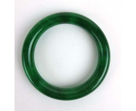 A green jade bangle, internal d. 5.9 cm