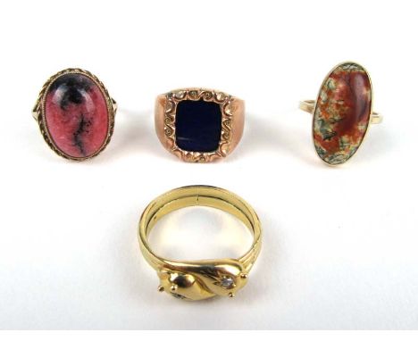 A group of four rings to include a 9ct gold lapis lazuli ring, a 9ct gold rhodonite ring, a yellow metal diamond crossover ri