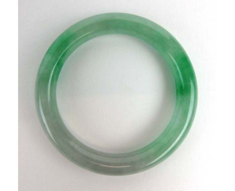 A green jade bangle, internal d. 5.6 cm
