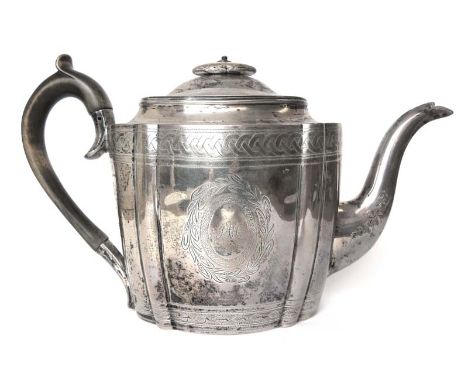 A George III silver teapot of oval form, having engraved entwining boarders and foliate decoration. Hallmarked for London, 17