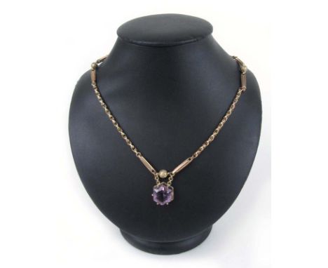 A Victorian 9ct gold amethyst pendant, the single hexagonal stone suspended from a fancy link chain. Approx weight 10.1g