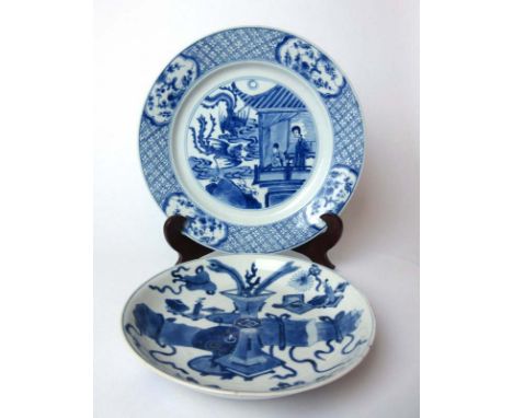 A Chinese blue and white plate decorated with peacocks and figures together with one smaller plate depicting a vase. Kangxi p