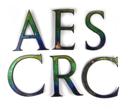 Six industrial style metal and enamel letters 'C A R E C S'