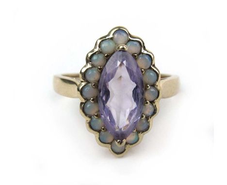 A 9ct gold amethyst and opal ring, the stones in a navette shaped setting. Approx weight 2.9g