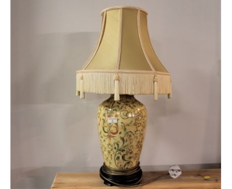Bulbous ceramic lamp base with gold tasselled shade, 68 cm high