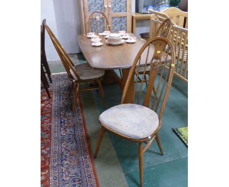 Ercol rectangular table with four Ercol swan backed chairs