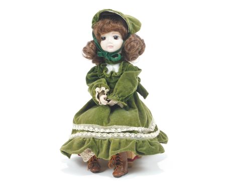 A musical automaton doll, with bisque head and hands, seated on a music box, wearing green velvet dress and hat