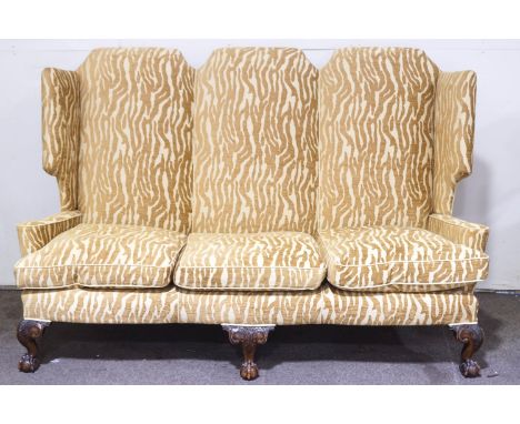 A large Victorian winged high back three seater sofa, upholstered in golden chenille with animal print (by Mulberry), support