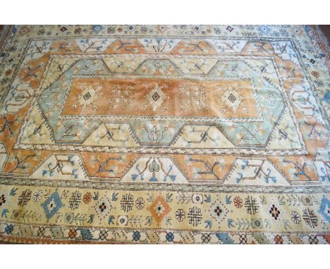 A large carpet with four medallions on a rectangular panel with three wide borders, 347cm x 251cm