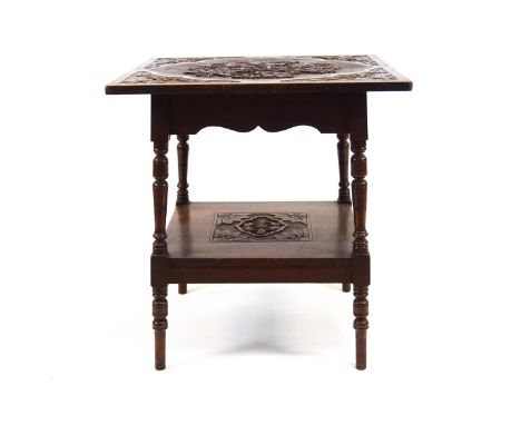 A Victorian mahogany occasional table, the top carved with grapes and vines, raised on turned baluster supports over a lower 