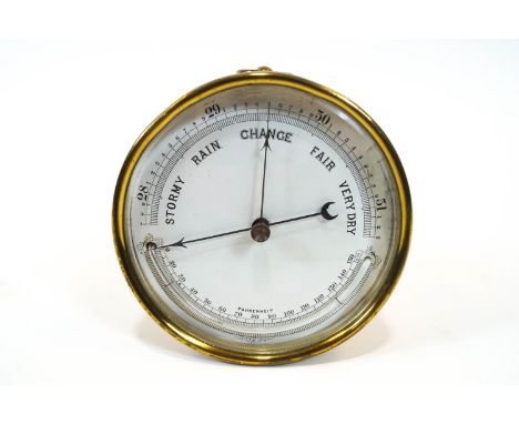 An aneroid barometer, of cylindrical form, with enamel dial enclosing a temperature gauge, 12.5cm diameter
