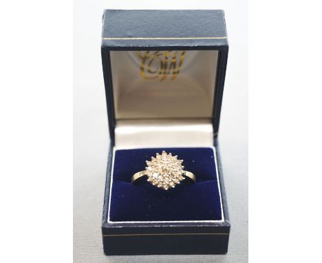 A yellow and white metal cluster ring. Set with thirty six round brilliant cut diamonds measuring from 1.50mm to 1.80mm. Esti