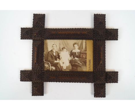 A marine art wood frame, inscribed 'Frame made by father of Mrs (?) from cigar boxes, made whilst sailor at sea, 1870', enclo