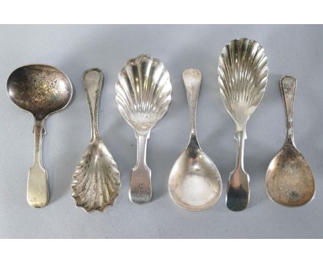 A group of silver plated caddy spoons, three with shell bowls