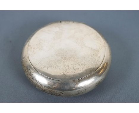A silver  pinch action tobacco/snuff box, of plain round form, Chester 1898, 8cm wide, 78 grams
