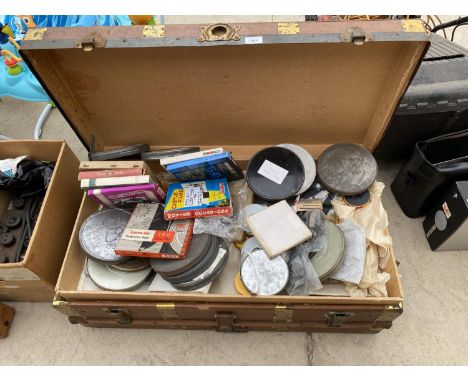A VINTAGE TRAVEL TRUNK CONTAINING A LARGE COLLECTION OF FILM REELS 