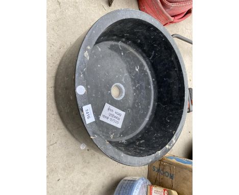 A SOLID BLACK MARBLE WASH BASIN 