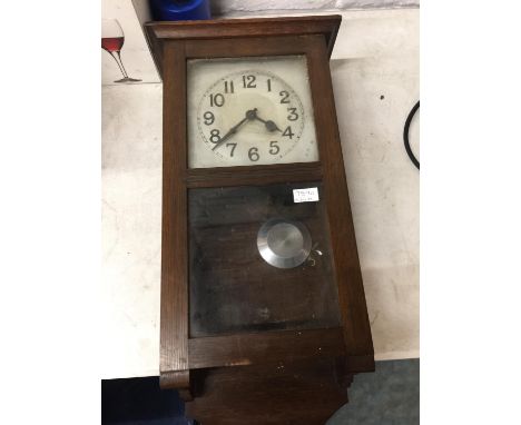 A VINTAGE WALL CLOCK IN A MAHOGANY CASE WITH PENDULUM AND KEY 